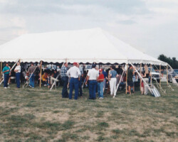 Photo of the Farmers Coop Exchange Community Picnic Under a Large Tent