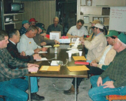 Photo of members of the Farmers Coop Exchange casting votes in 2001